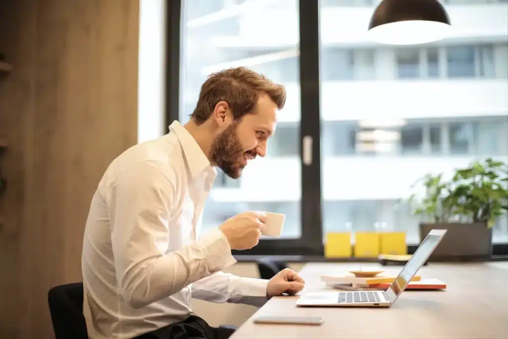 Smiling man drinking coffee