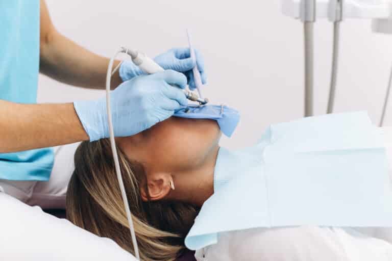 dentist examining woman in a dental office