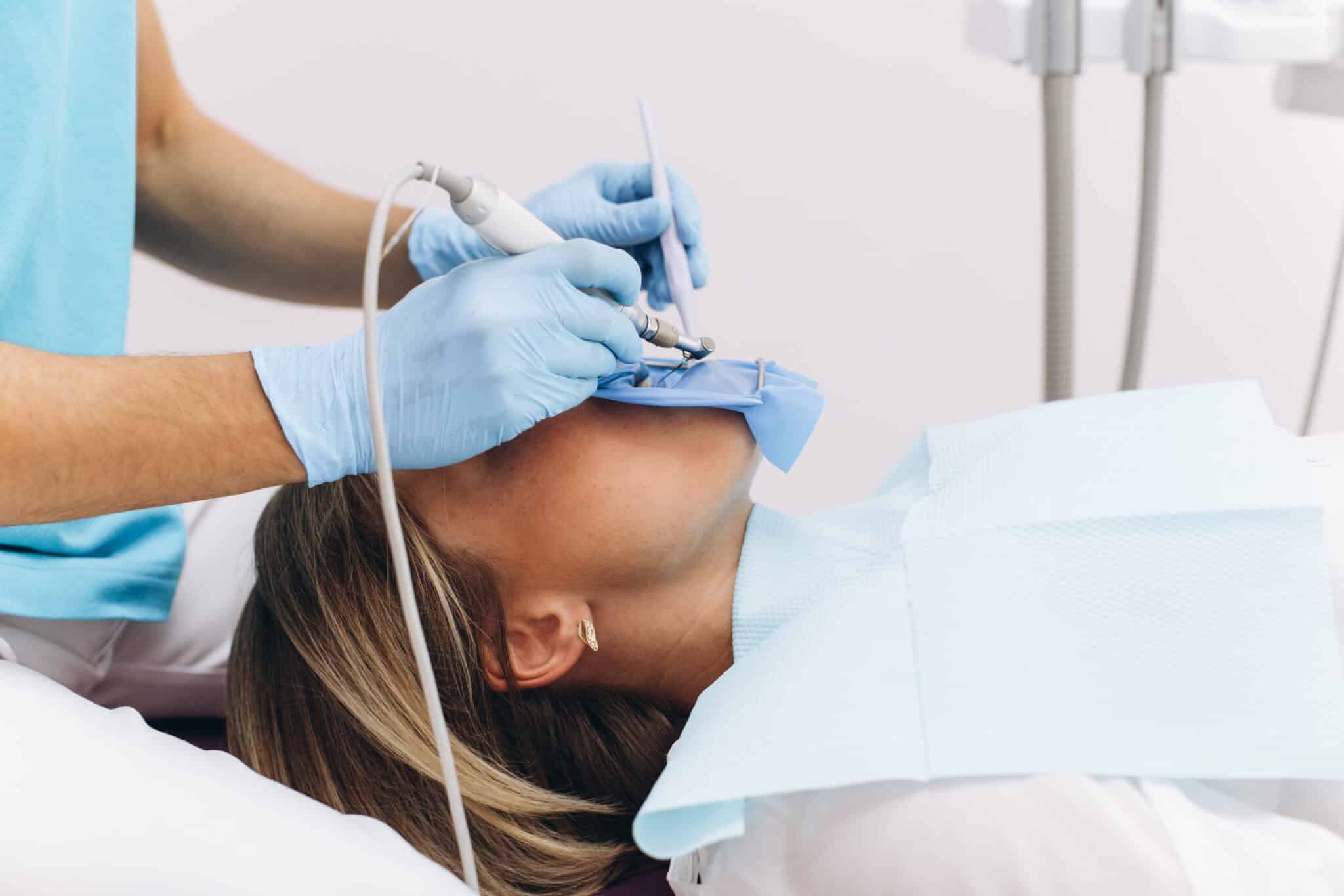 dentist examining woman in a dental office